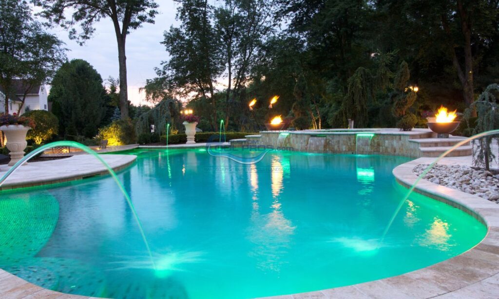 freeform inground pool installation with lights, water jets, water falls, gas fire bowls, bull nose coping and travertine pool deck, luxury pool builder