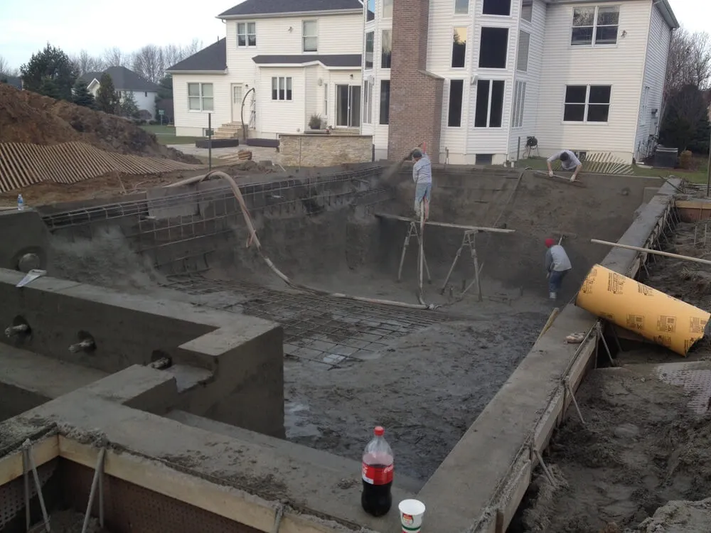 applying gunite concrete over rebar in an inground swimming pool construction build