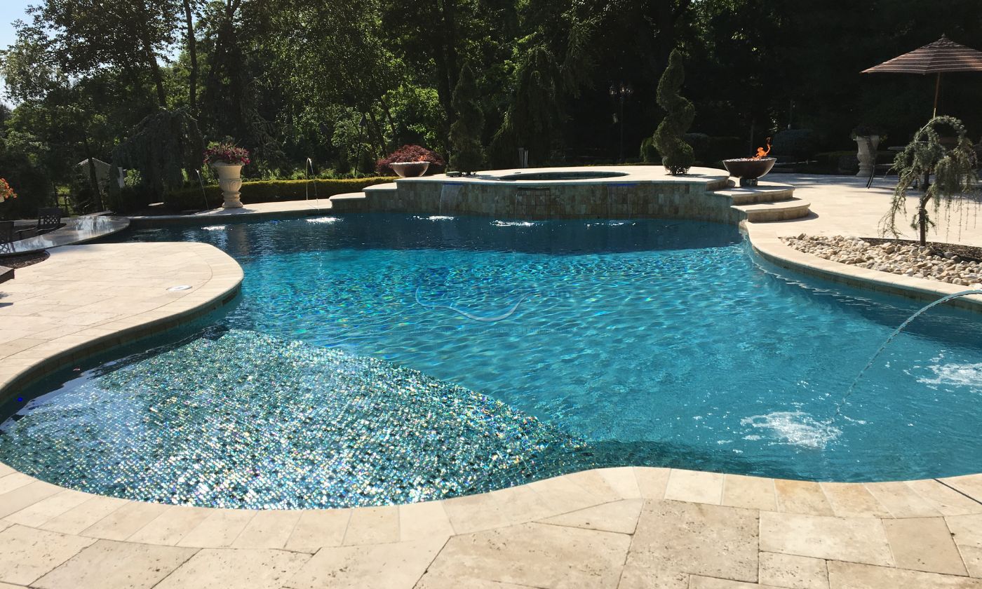 freeform inground gunite concrete pool with spa, water jets, fire pits, travertine durable natural slip-resistant stone pool patio deck, inground pool
