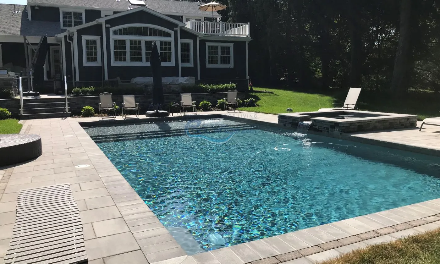 inground pool with spa and pool deck, patio with chairs on backyard, inground pool