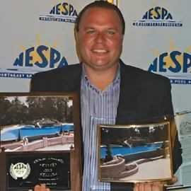Custom pool builders serving Pennsylvania, standing beside NESPA pool awards
